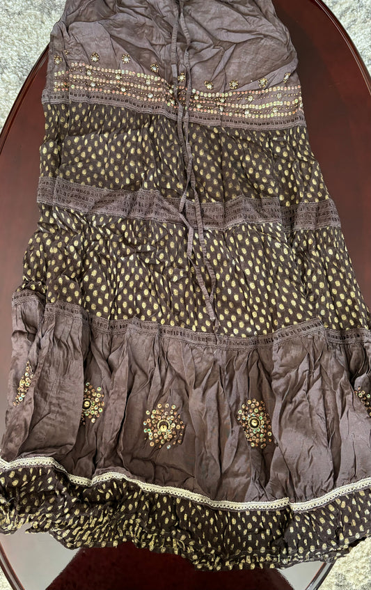 Beautiful gold work in brown long skirt.